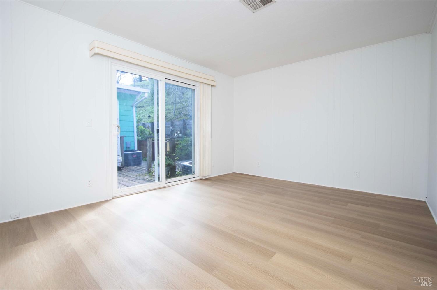 10 Fallen Leaf Way Novato, CA 94949 - Photo 16 of 30 an empty room with wooden floor and windows