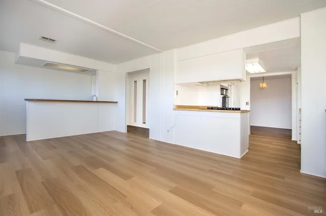 a view of a kitchen with a sink and a refrigerator