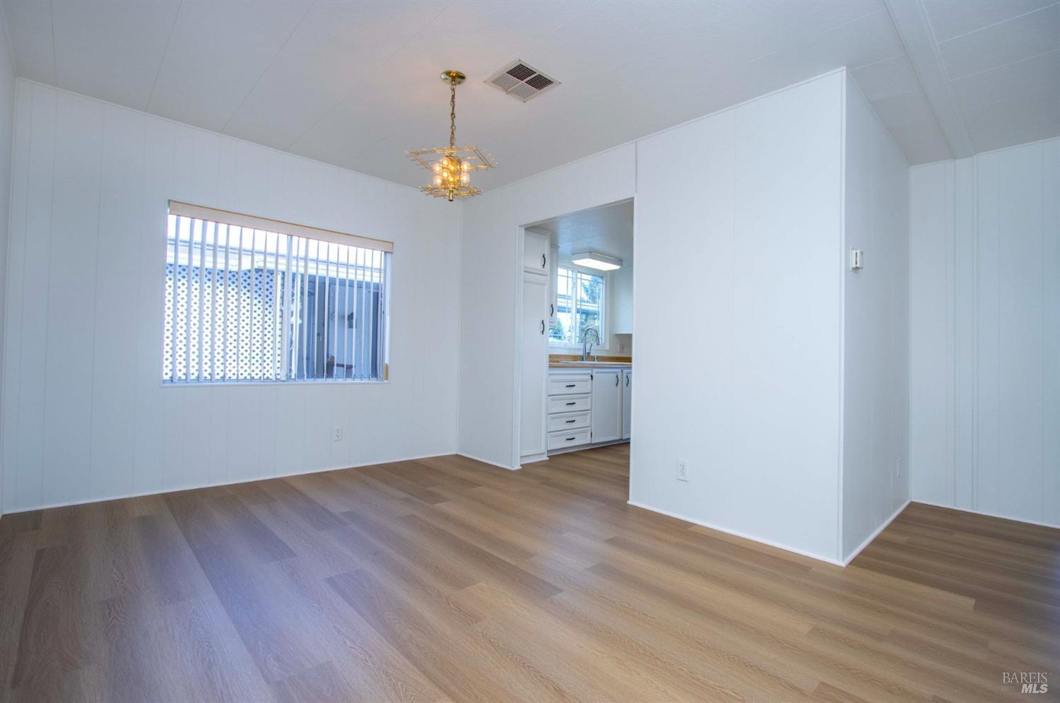 10 Fallen Leaf Way Novato, CA 94949 - Photo 7 of 30 an empty room with wooden floor and windows