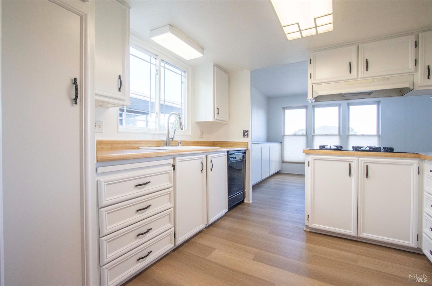 10 Fallen Leaf Way Novato, CA 94949 - Photo 9 of 30 a kitchen with white cabinets and white appliances