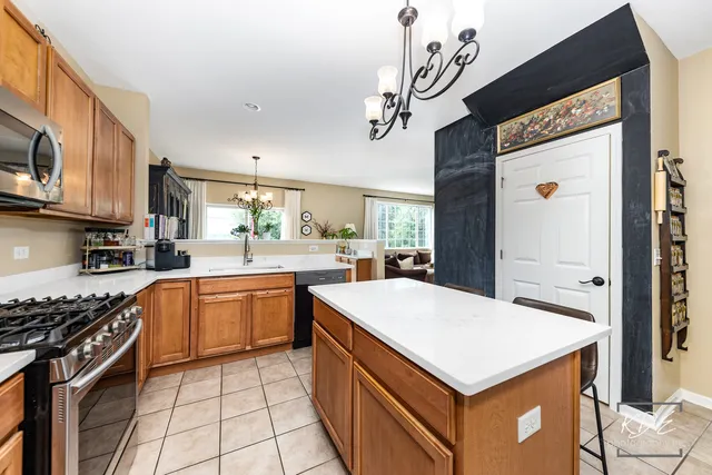 a kitchen with a stove cabinets and wooden floor