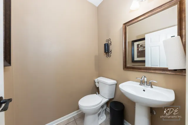 a bathroom with a sink toilet and mirror