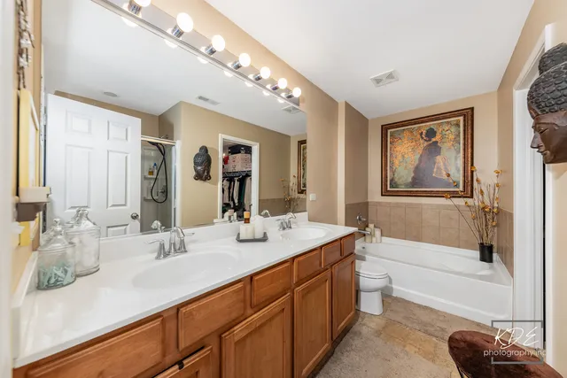 a bathroom with a tub sink and mirror