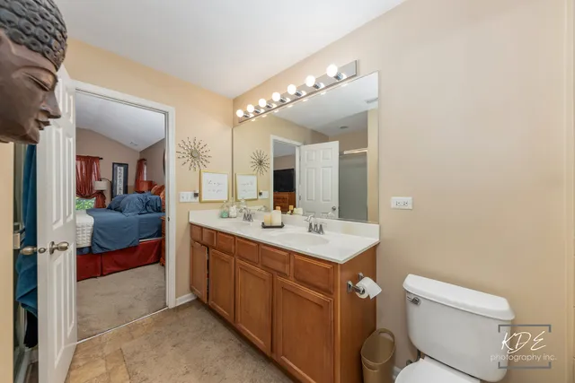 a spacious bathroom with a toilet sink and mirror