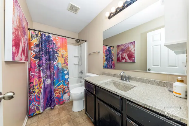 a bathroom with a sink mirror and a shower