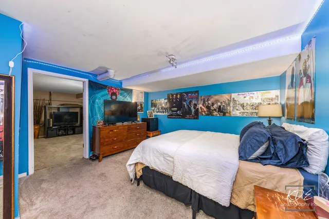 a bed room with a bed and a chair