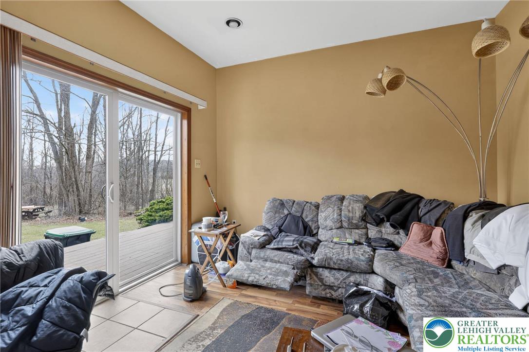 650 Chapman Lake Road Scott Township, PA 18433 - Photo 38 of 52 a living room with furniture and a floor to ceiling window