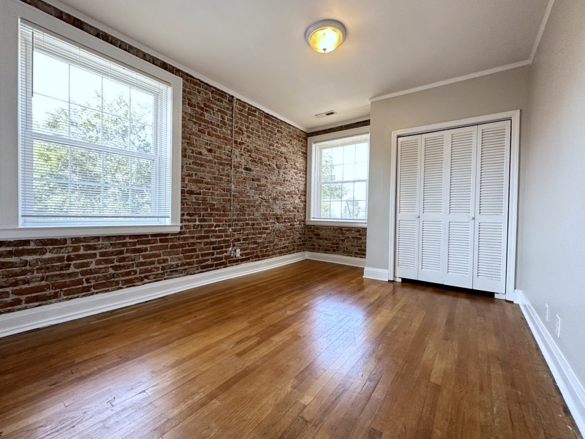 610 North 2nd Street, Unit 8 Clarksville, TN 37040 - Photo 22 of 29 an empty room with wooden floor and windows