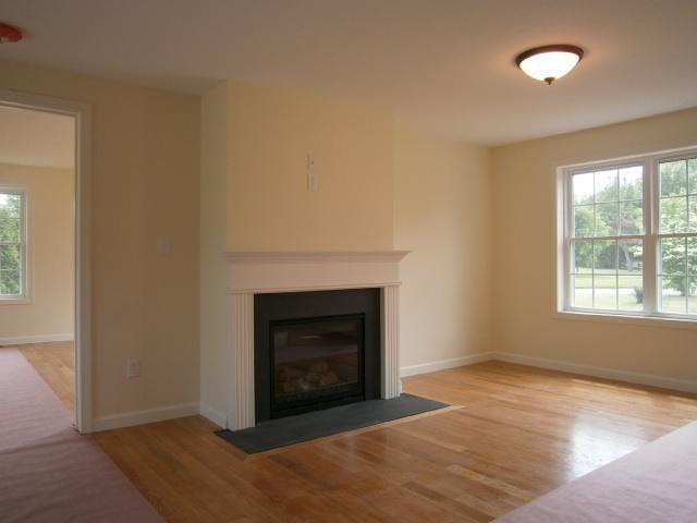 9 Knoll Top Road Forestdale, MA 02644 - Photo 5 of 16 an empty room with a fireplace and window