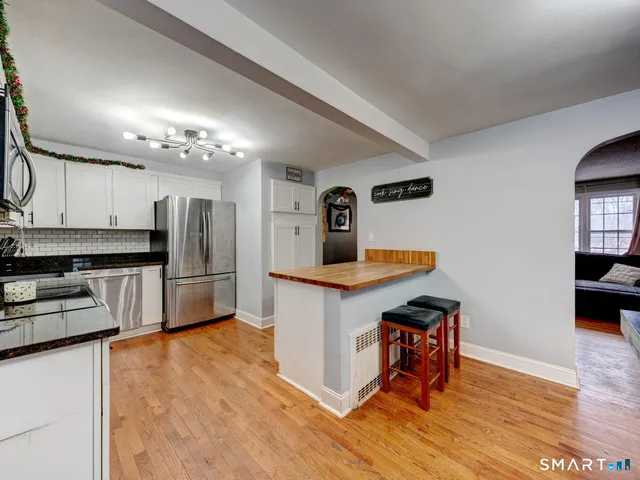 a kitchen with stainless steel appliances a refrigerator and a stove top oven