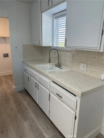 a kitchen with a sink cabinets and window