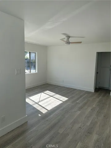 a view of wooden floor and windows in a room