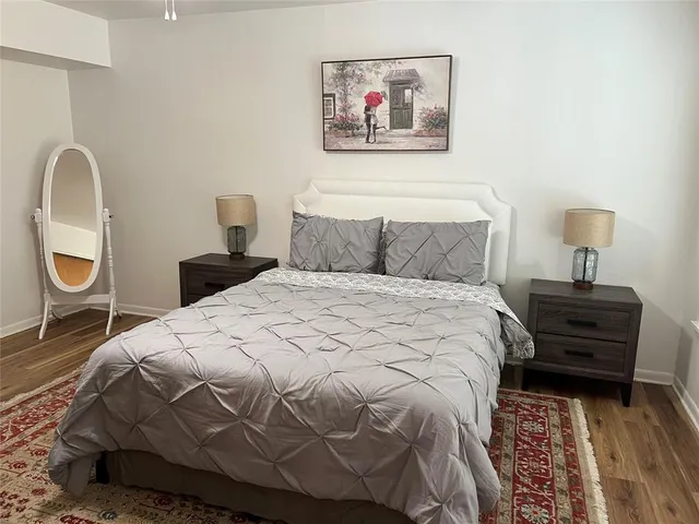 a bedroom with a bed and a lamp