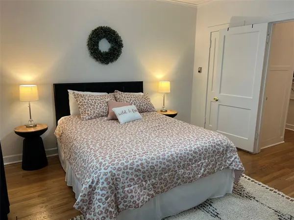 a bedroom with a bed and lamps