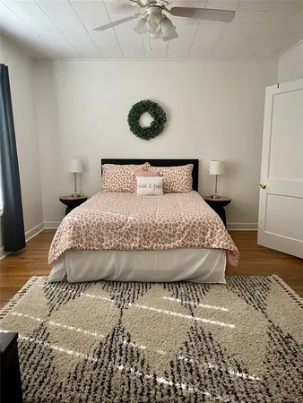a large bed sitting in a bedroom next to a window