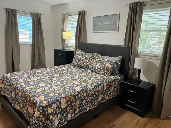 a bed sitting in a bedroom next to a window