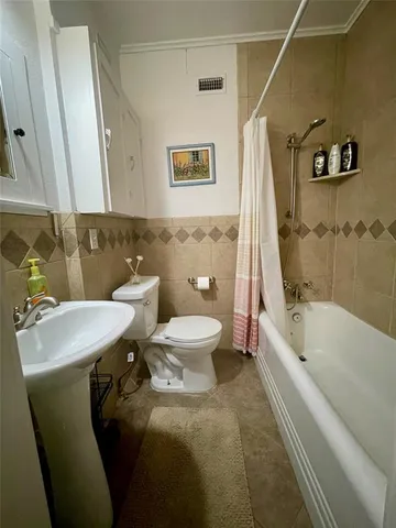 a bathroom with a sink mirror toilet and bathtub