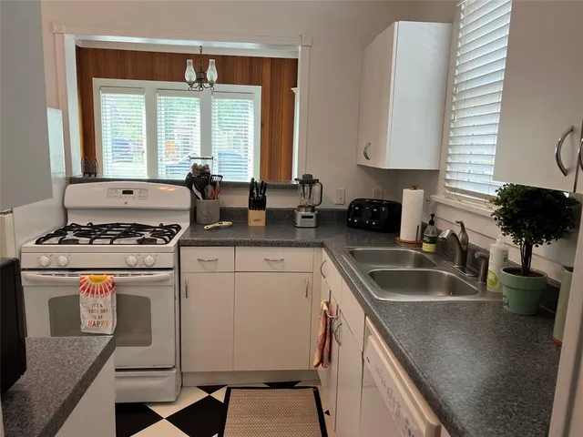 a kitchen with a stove a sink and a refrigerator