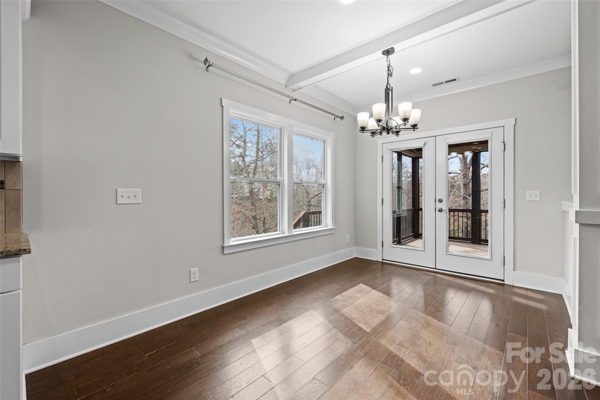 12039 Spinnaker Drive Tega Cay, SC 29708 - Photo 12 of 48 a view of an empty room with chandelier and window