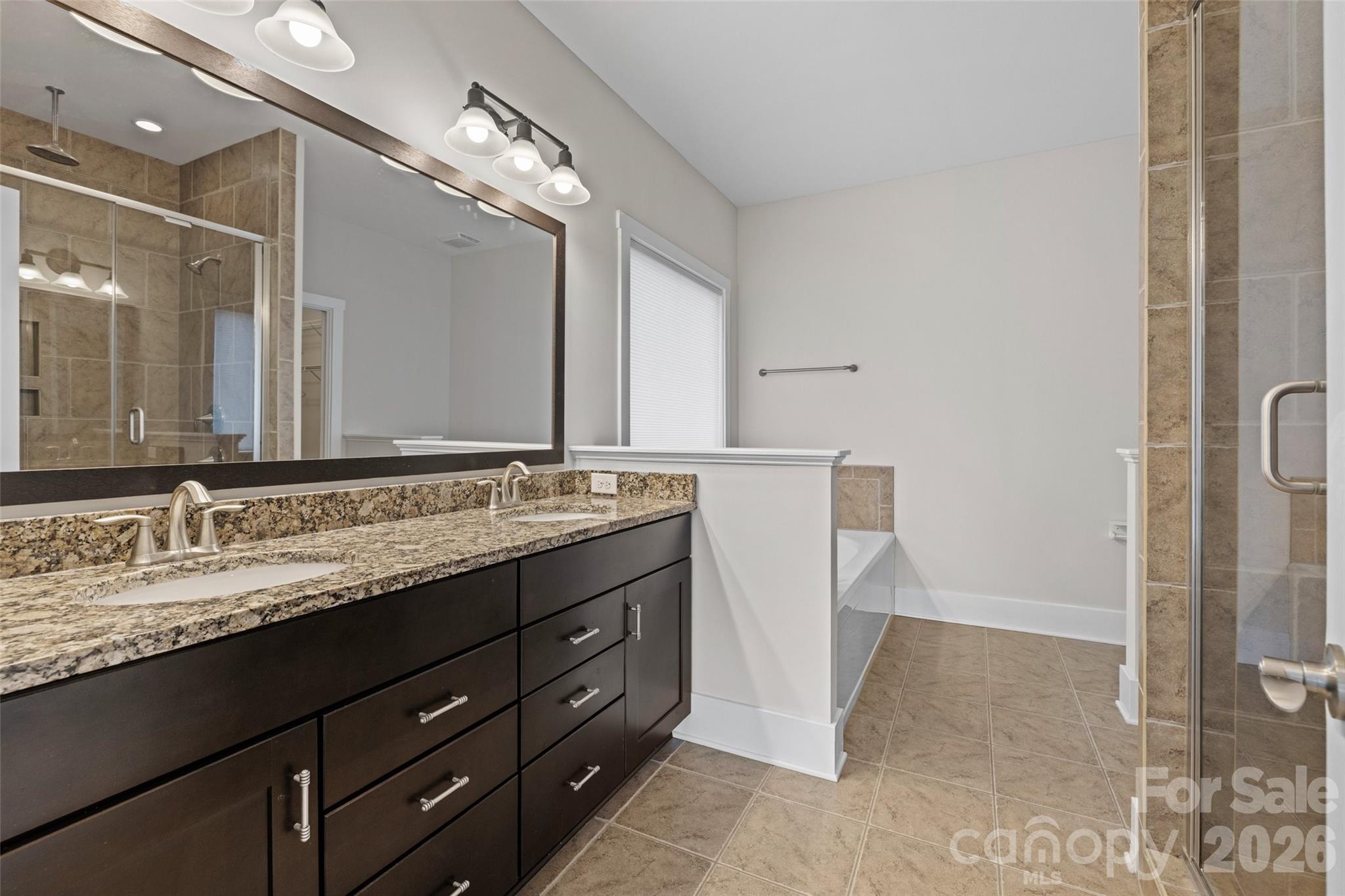 12039 Spinnaker Drive Tega Cay, SC 29708 - Photo 15 of 48 a bathroom with a granite countertop sink and a mirror