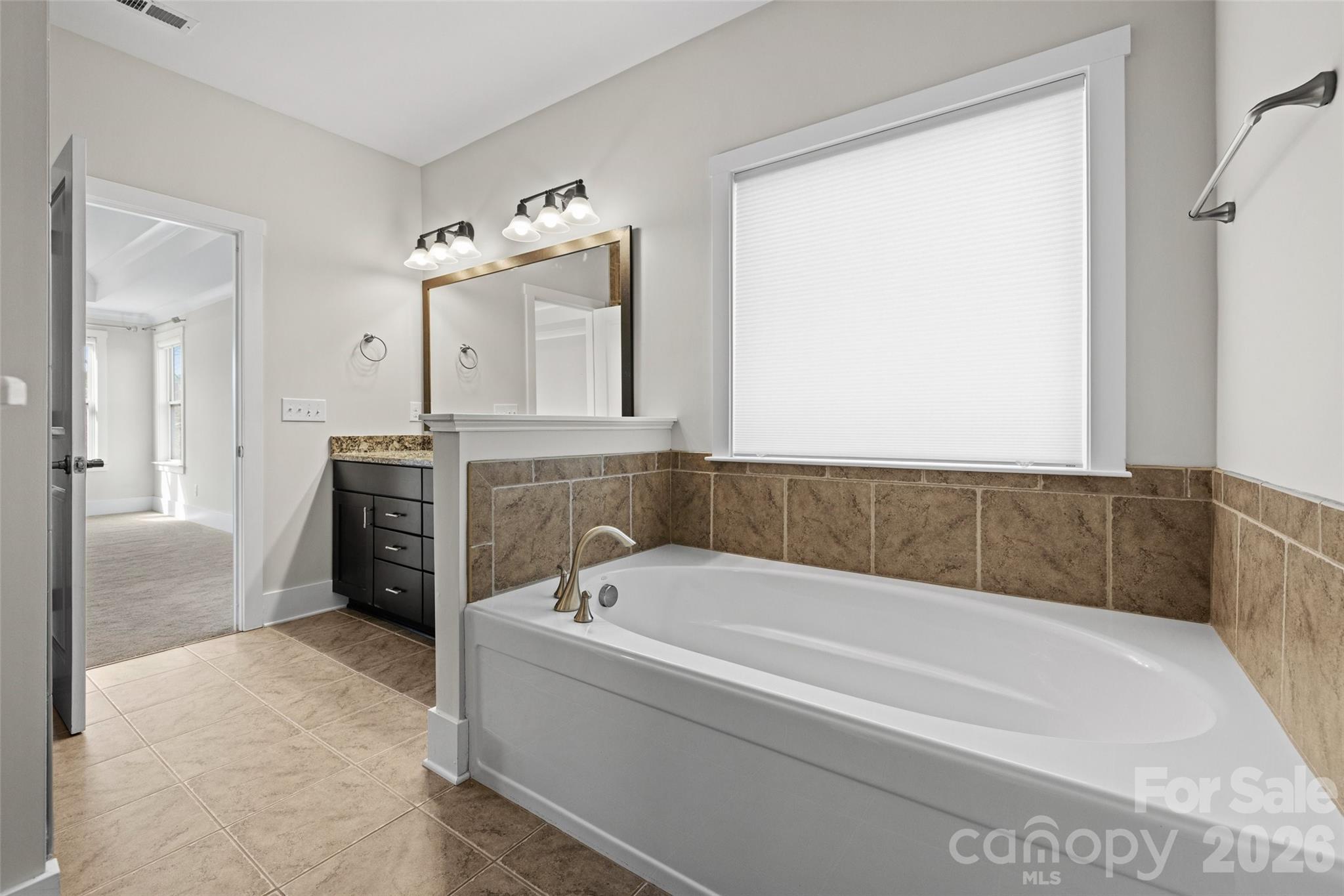 12039 Spinnaker Drive Tega Cay, SC 29708 - Photo 16 of 48 a bathroom with a bathtub and a shower