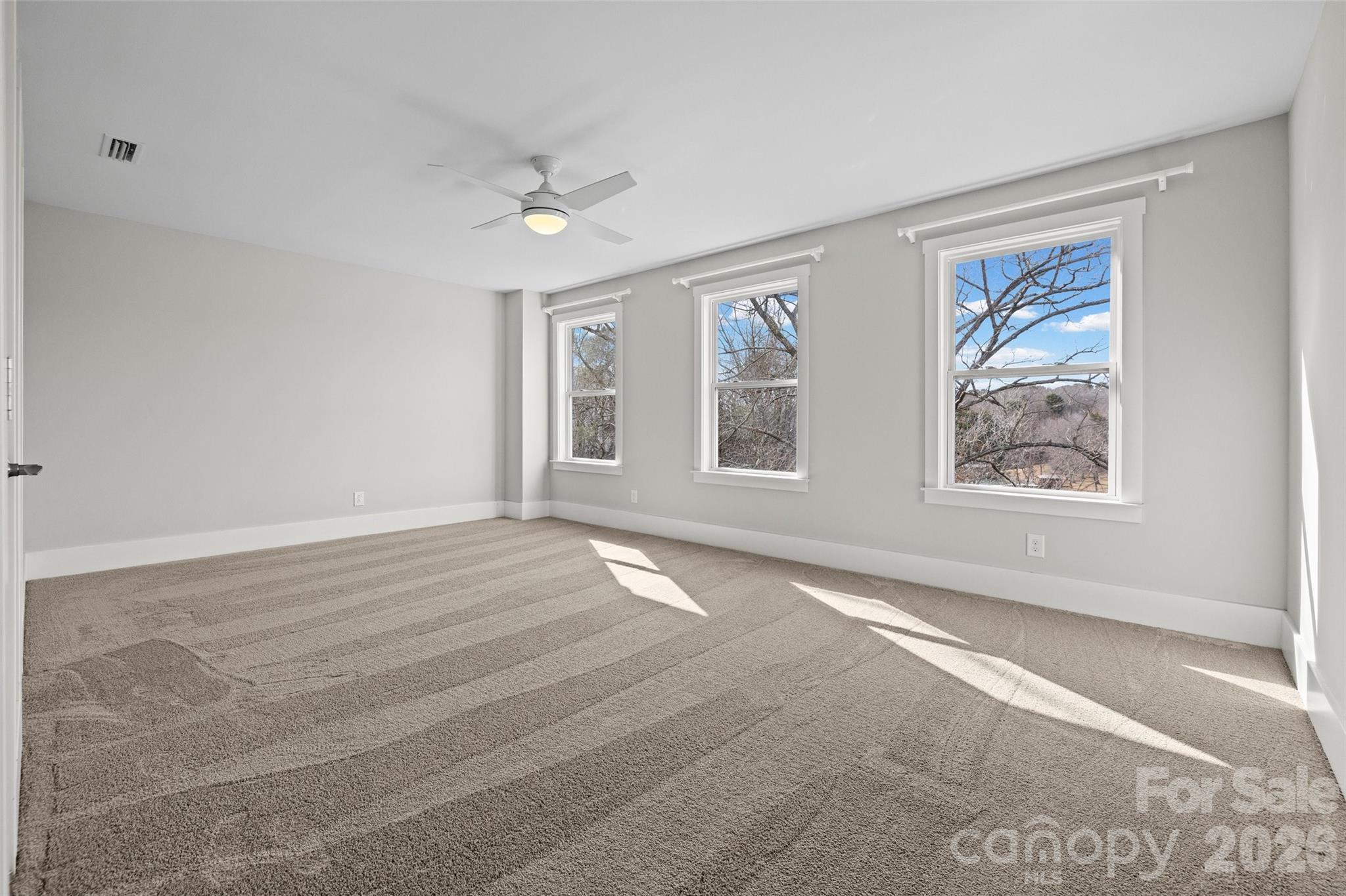 12039 Spinnaker Drive Tega Cay, SC 29708 - Photo 20 of 48 a view of an empty room with a window and closet