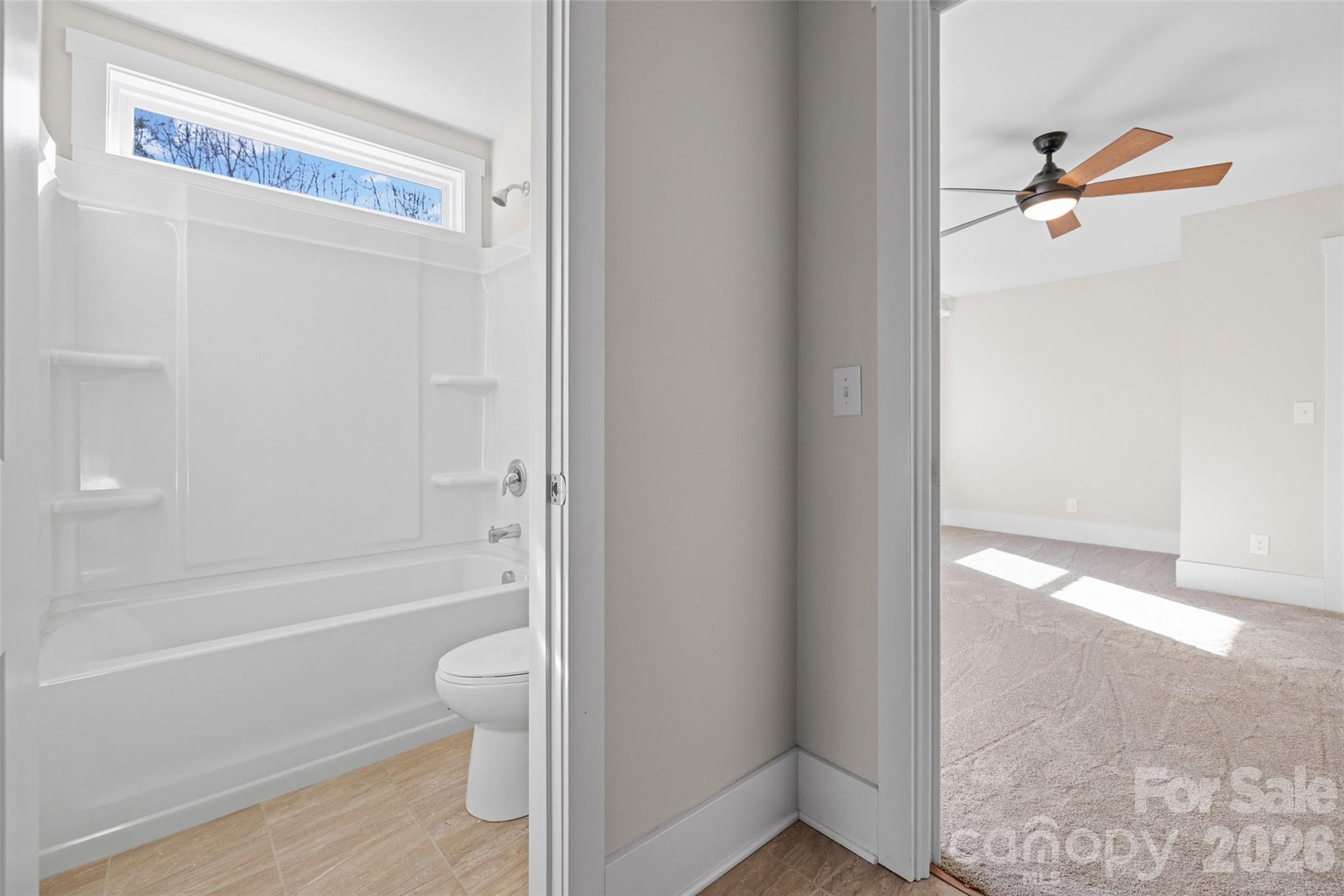 12039 Spinnaker Drive Tega Cay, SC 29708 - Photo 25 of 48 a bathroom with a granite countertop bathtub shower and toilet