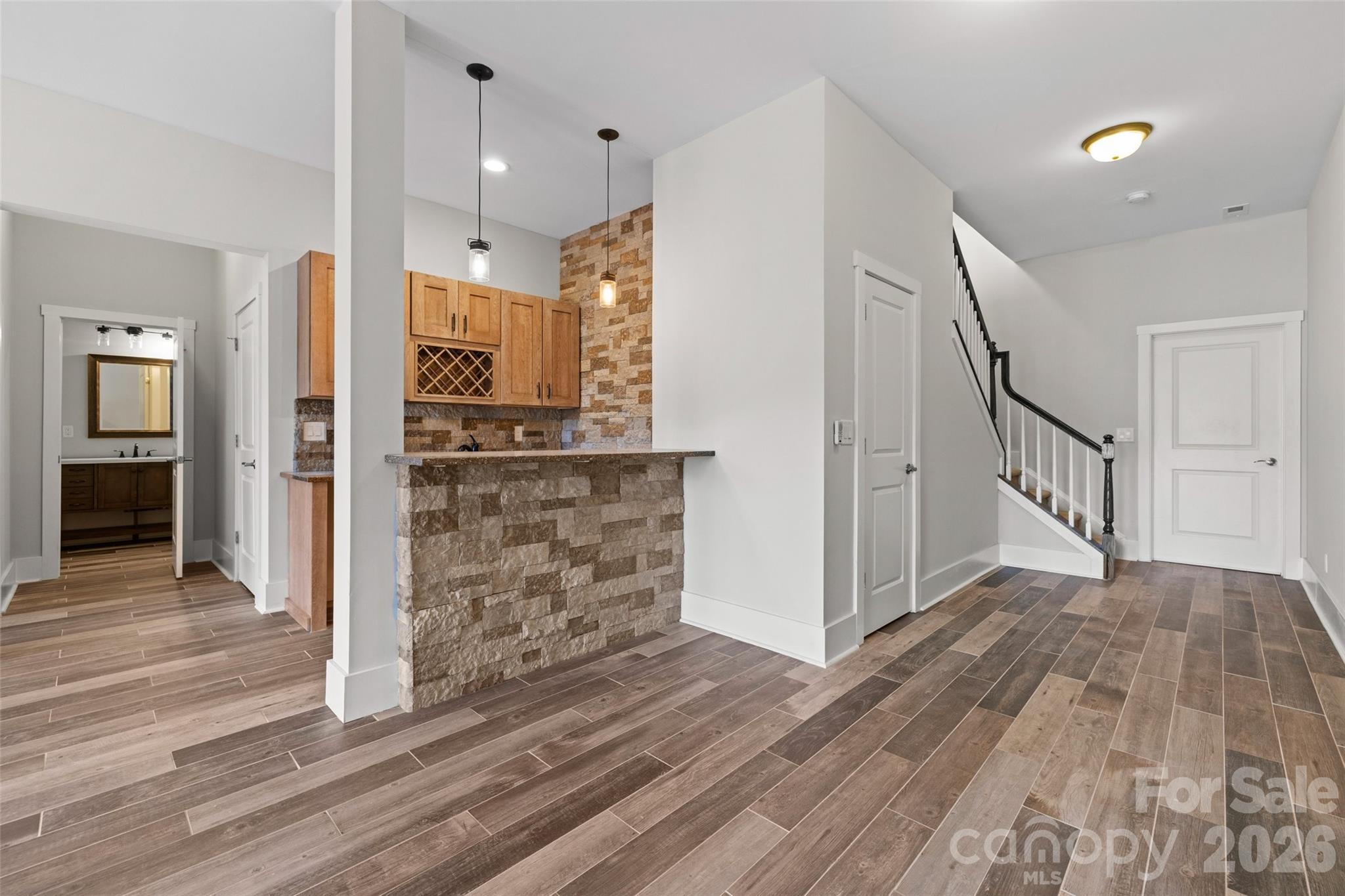 12039 Spinnaker Drive Tega Cay, SC 29708 - Photo 29 of 48 a view of a hallway with wooden floor and staircase