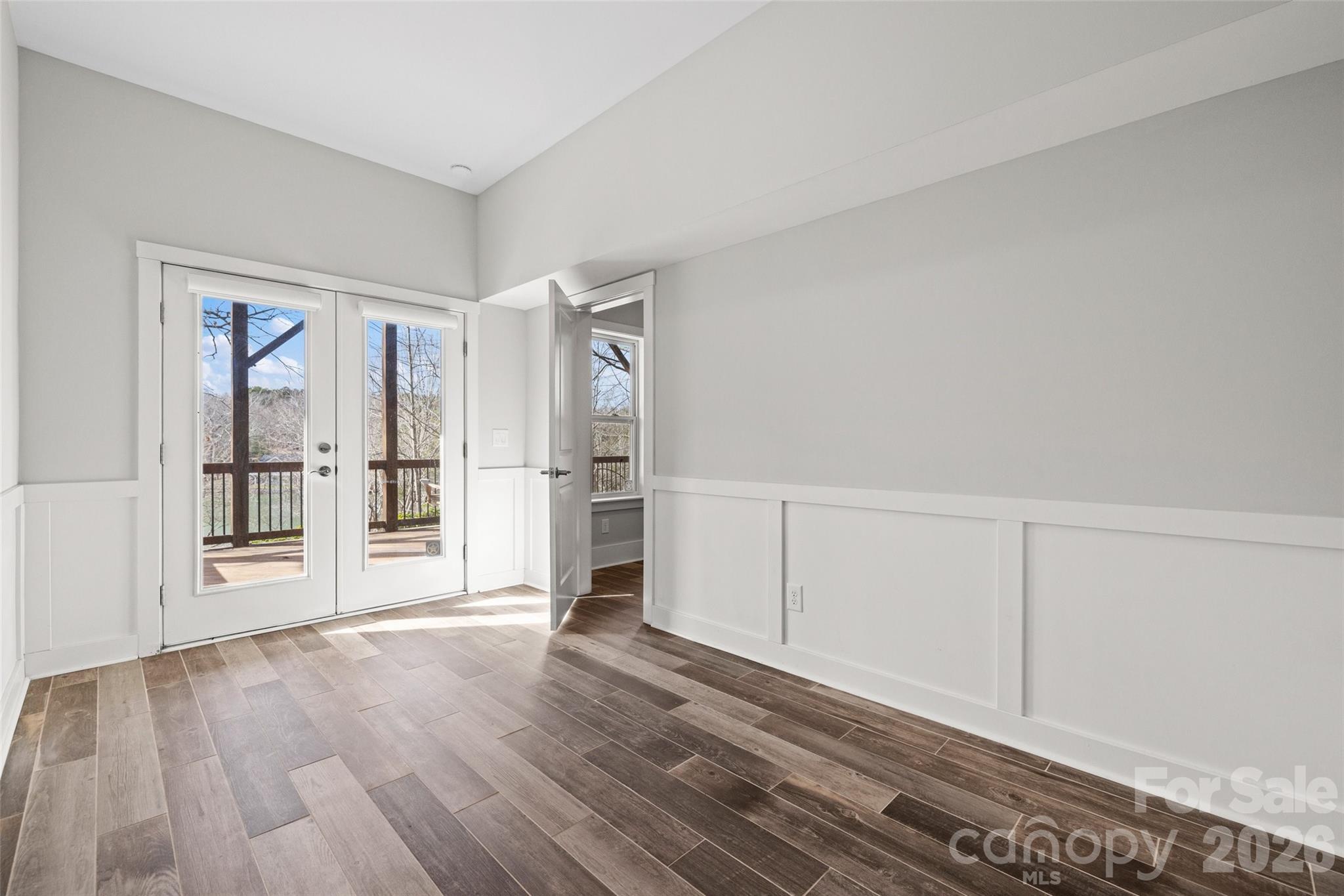 12039 Spinnaker Drive Tega Cay, SC 29708 - Photo 32 of 48 a view of an empty room with wooden floor and a window