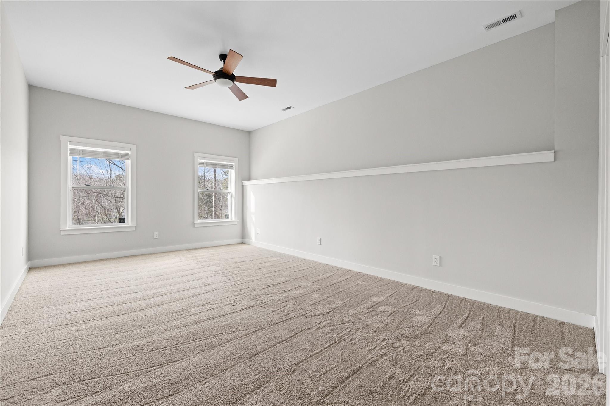 12039 Spinnaker Drive Tega Cay, SC 29708 - Photo 33 of 48 wooden floor in an empty room with a window