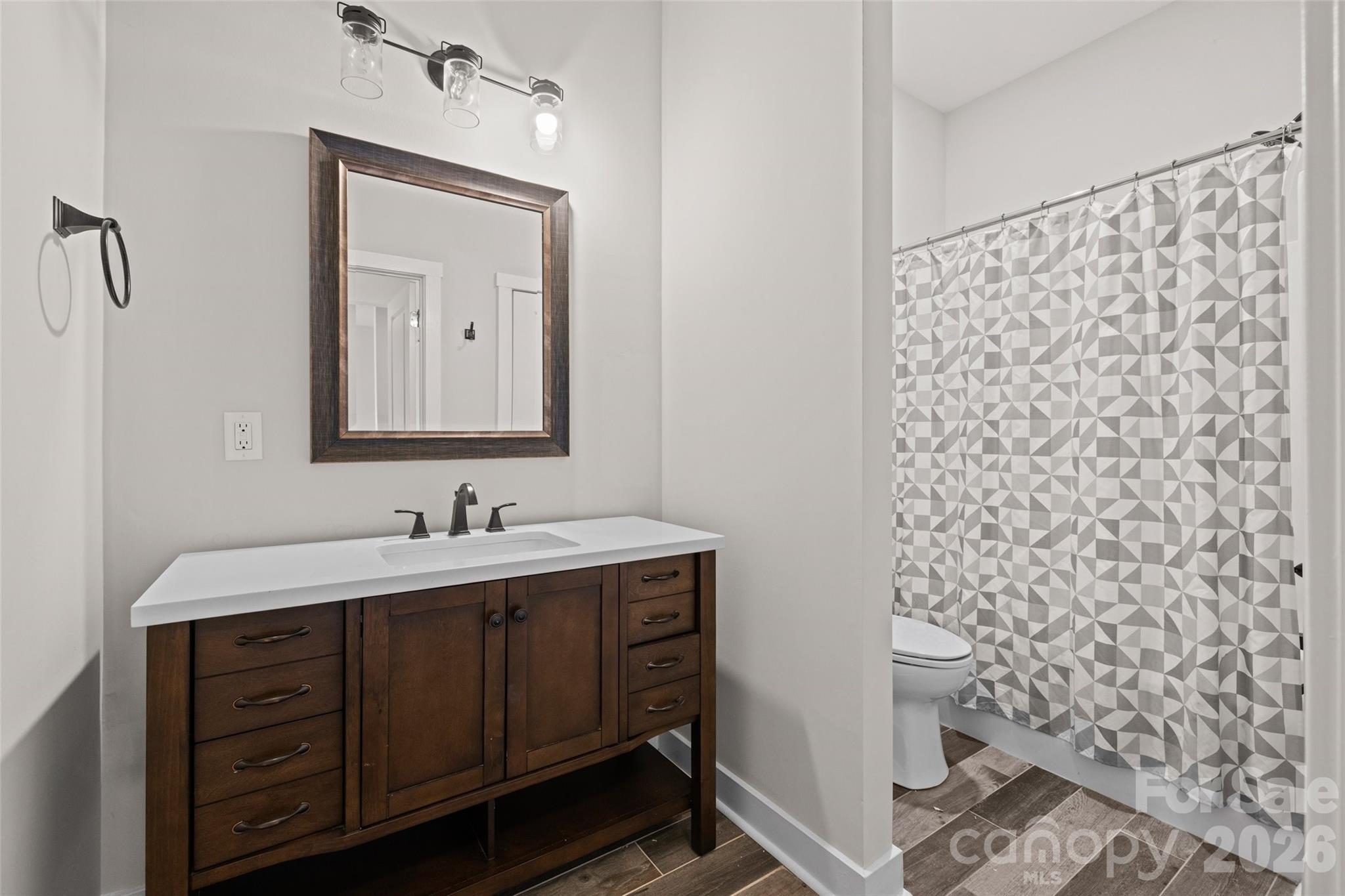 12039 Spinnaker Drive Tega Cay, SC 29708 - Photo 35 of 48 a bathroom with a sink a toilet and mirror