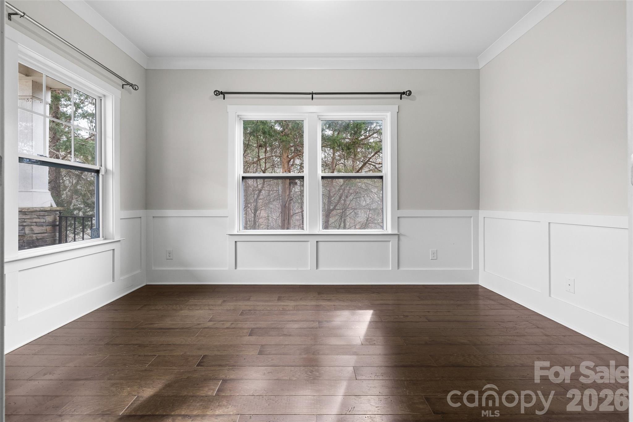 12039 Spinnaker Drive Tega Cay, SC 29708 - Photo 6 of 48 a view of an empty room with wooden floor and a window