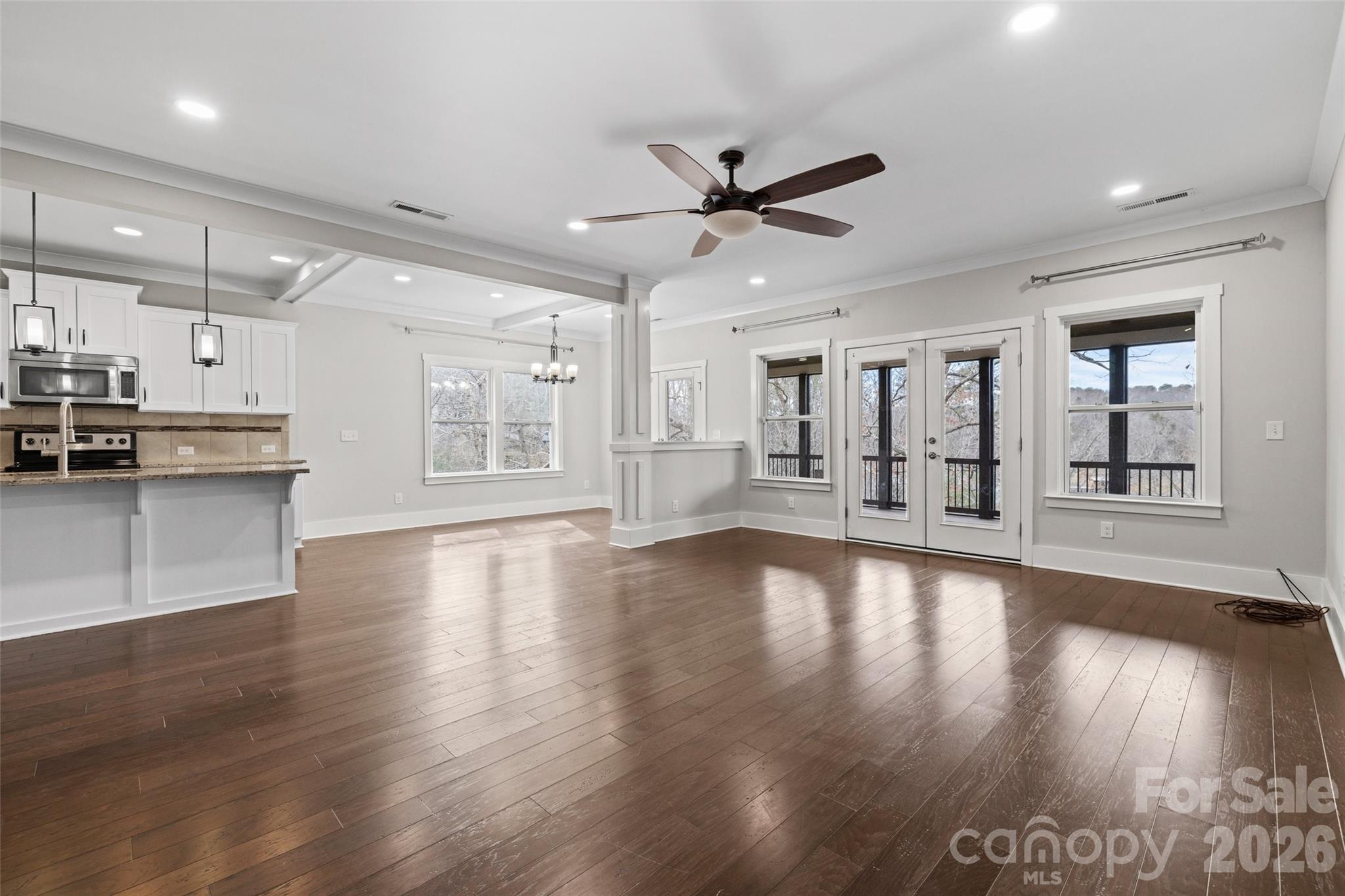 12039 Spinnaker Drive Tega Cay, SC 29708 - Photo 8 of 48 a view of an empty room with window and wooden floor