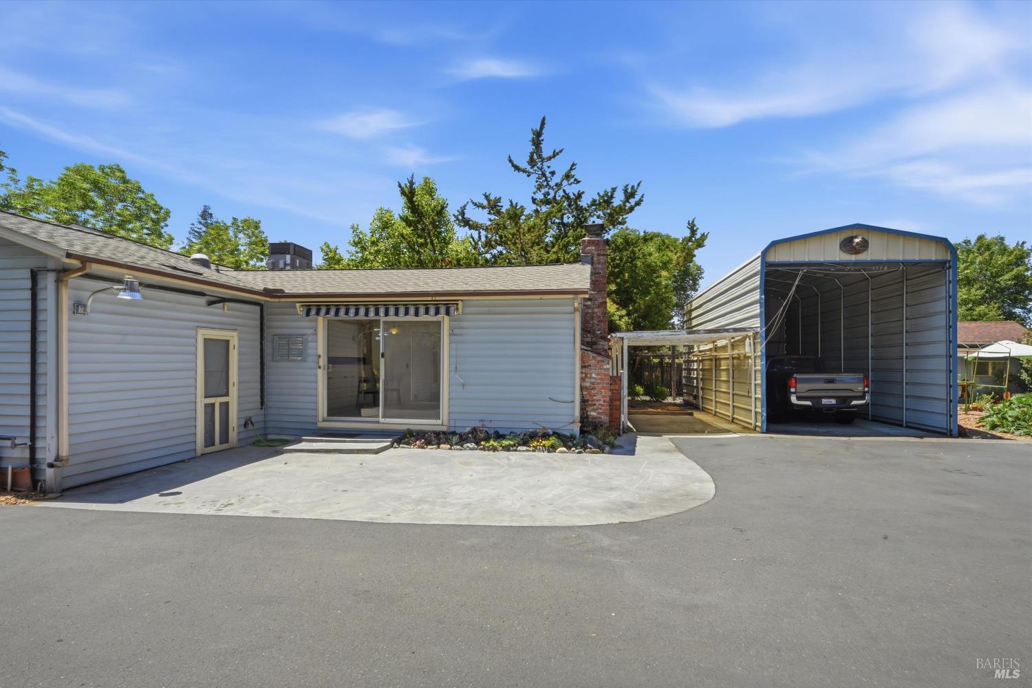 4941 Hansen Drive Santa Rosa, CA 95409 - Photo 30 of 35 Side and back of house as seen from north edge of driveway. Plenty of paved parking including covered carport and RV carport. Sliding door leads into family room. Door on left leads into the house thru the laundry room.