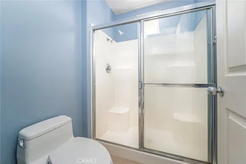 a bathroom with a glass shower door