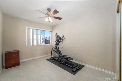a room with gym equipment and windows