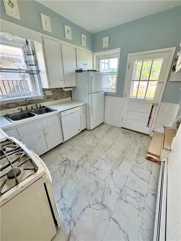 a kitchen with a stove and a refrigerator