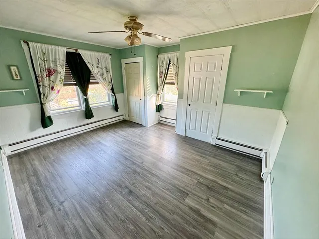 a view of a hallway with wooden floor and stairs