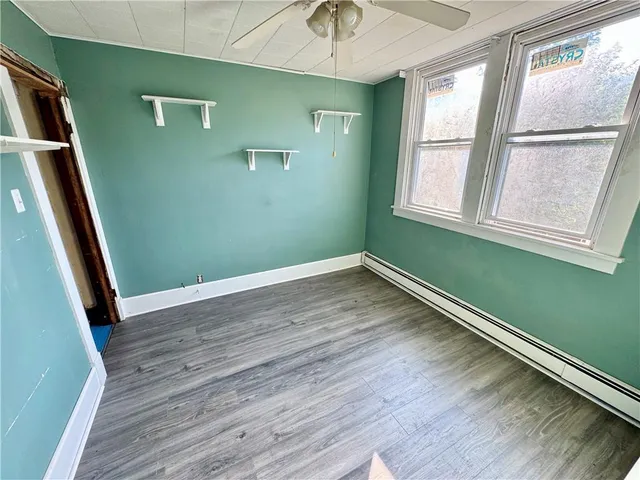 a view of a room with wooden floor and windows