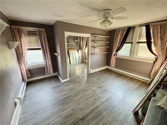 wooden floor in an empty room with a window