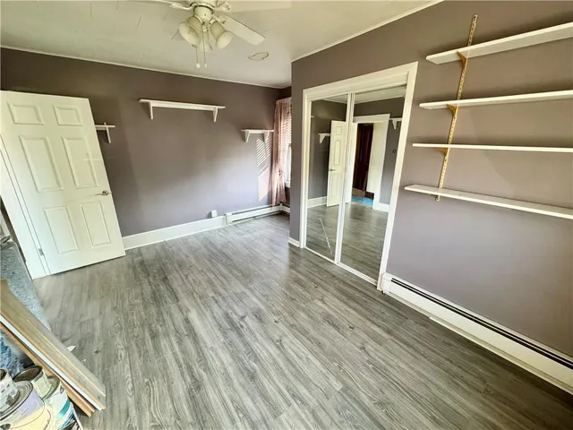 an empty room with wooden floor and a window