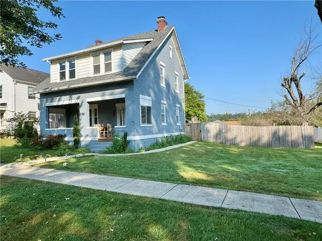 a view of house with a yard