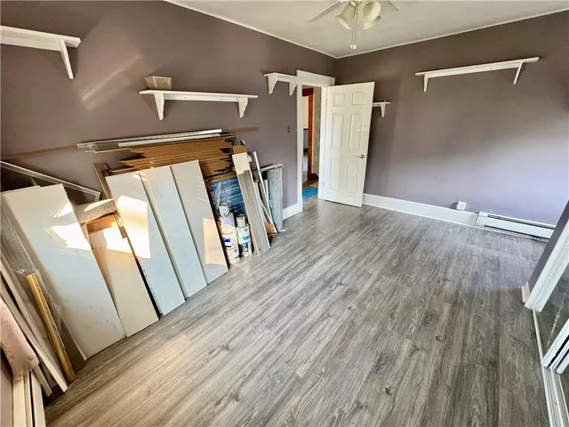 a view of a room with wooden floor