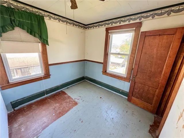 a room with window and a wooden door