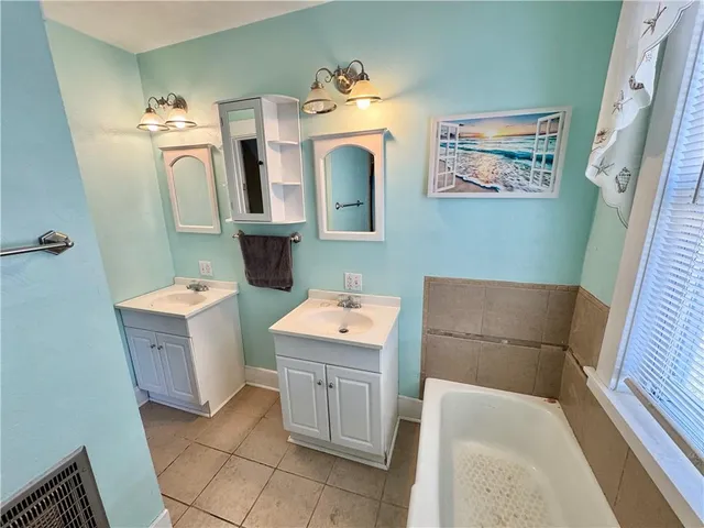 a bathroom with a sink a toilet and mirror