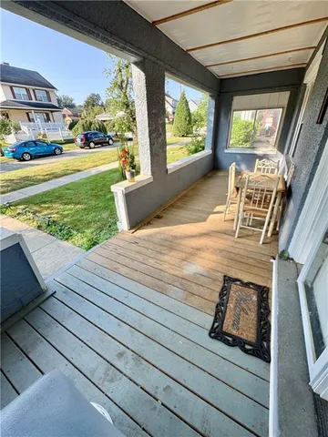 a view of a porch and wooden floor