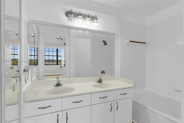a bathroom with a sink double vanity and a mirror