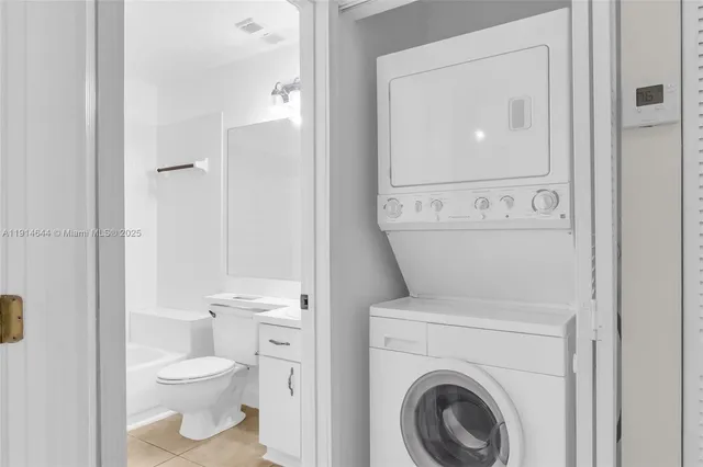 a white toilet sitting next to a bathroom sink