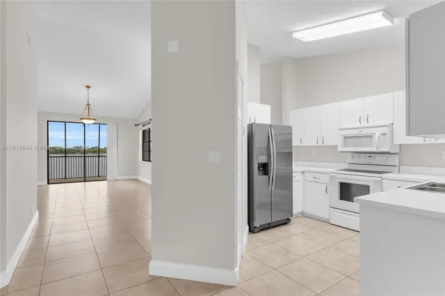 a kitchen with stainless steel appliances a refrigerator sink and cabinets