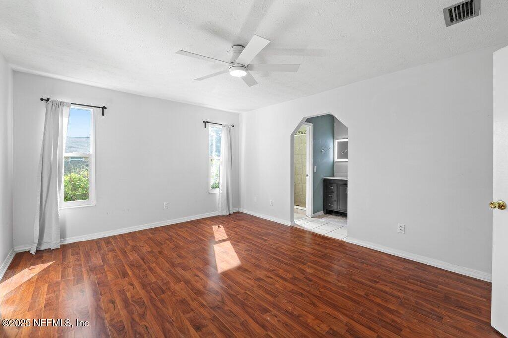 11631 East Ride Drive Jacksonville, FL 32223 - Photo 11 of 28 a view of an empty room with wooden floor and a window